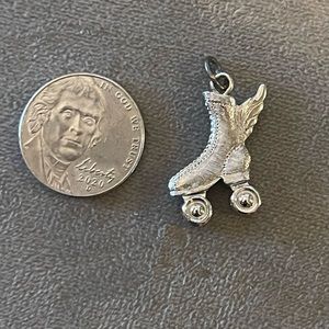 Flying rollerblade charm with moving wheels